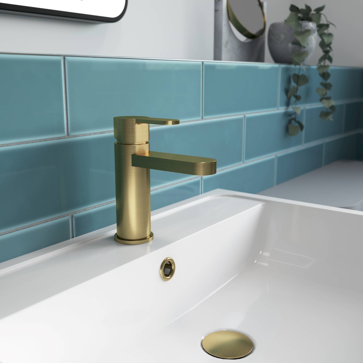 brushed brass tap with blue tiles
