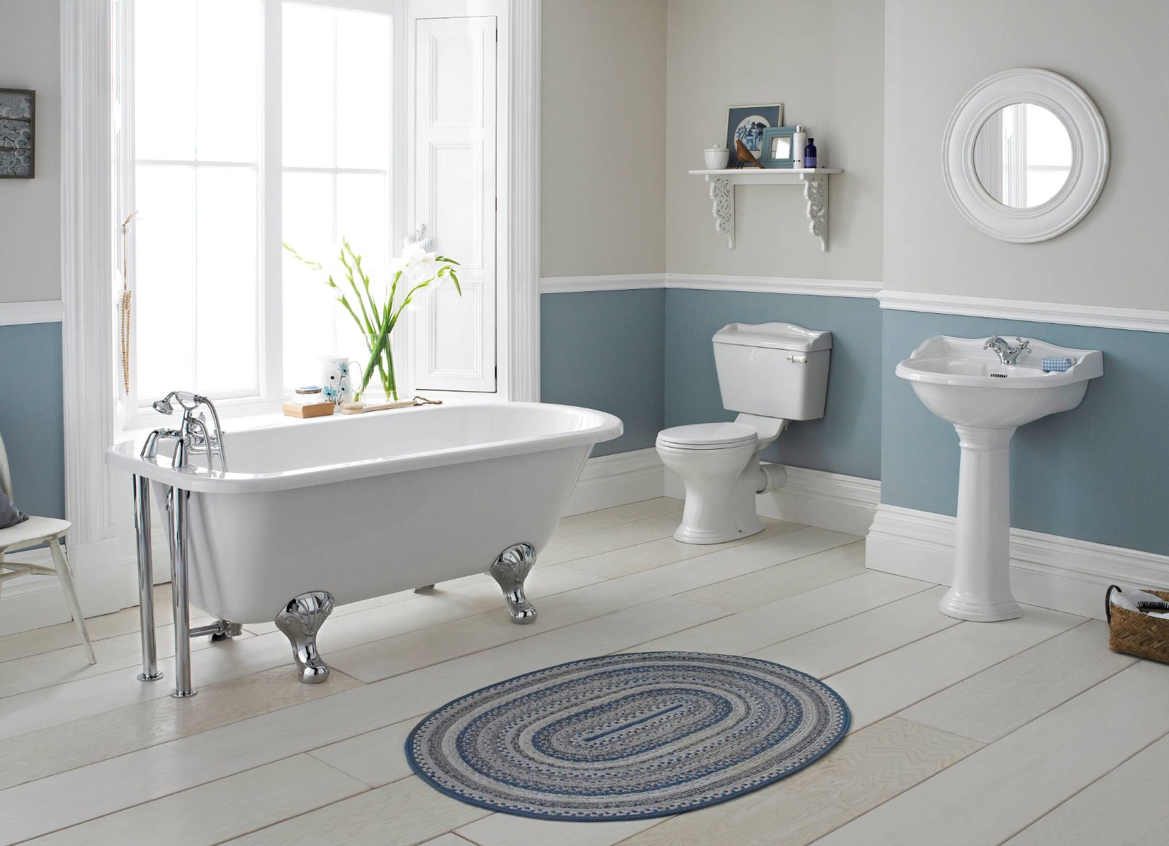 wooden flooring with traditional roll top bath in bathroom