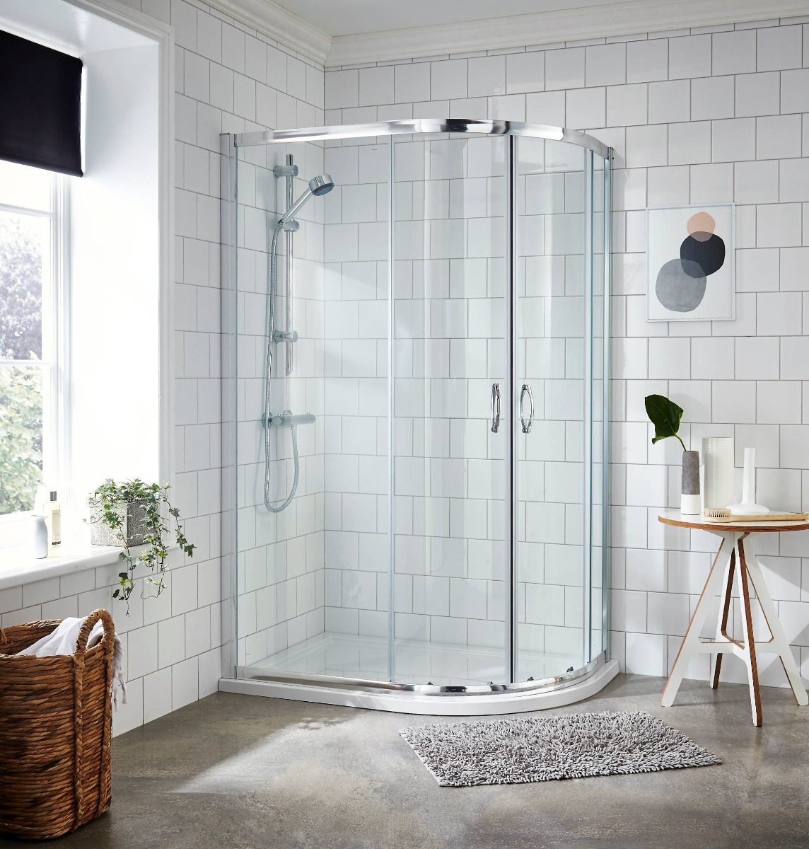offset quadrant shower in white tiled bathroom
