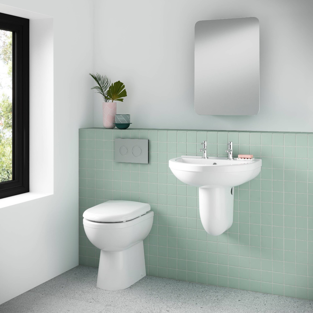 back to wall toilet in white and mint green bathroom