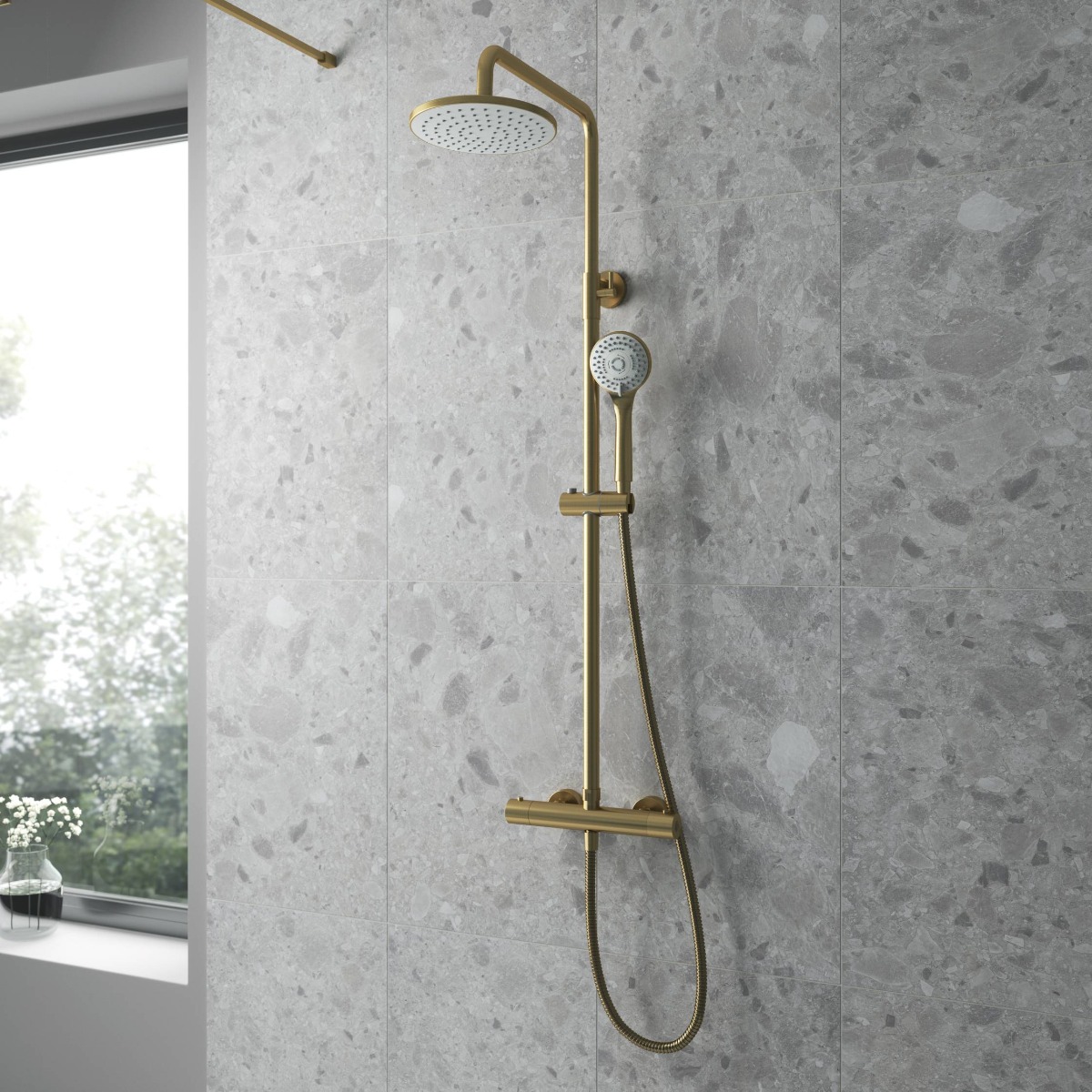 brushed brass shower on grey panelled wall
