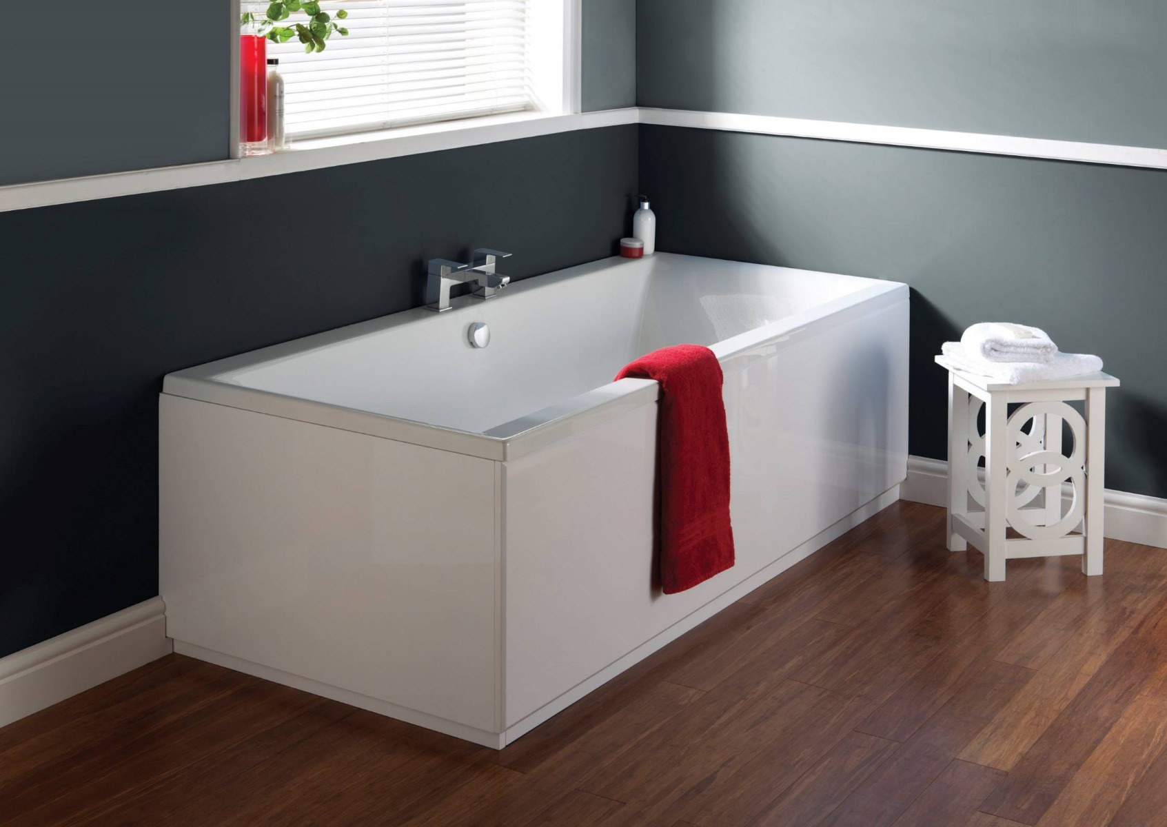 grey bathroom with bath and red towel